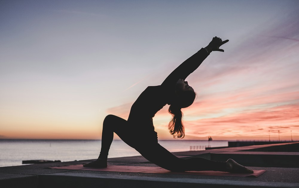 A yoga practitioner stretching on a mat